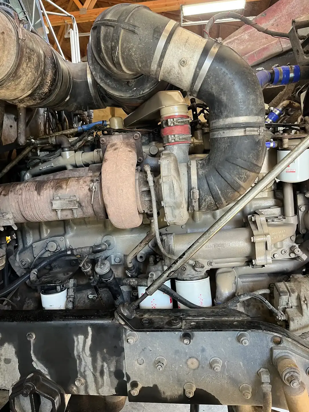A certified technician carefully working on a heavy-duty engine